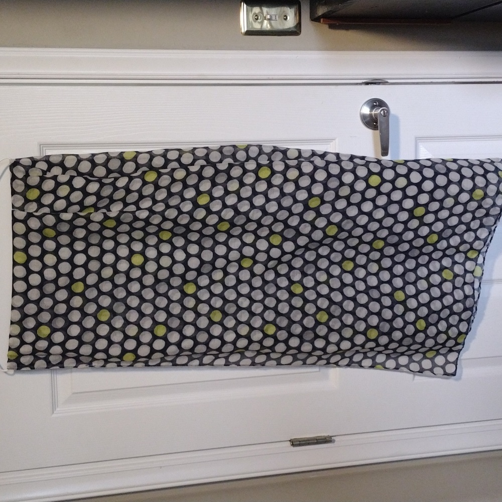 Large scarf navy background with white and a few green polka dots.
